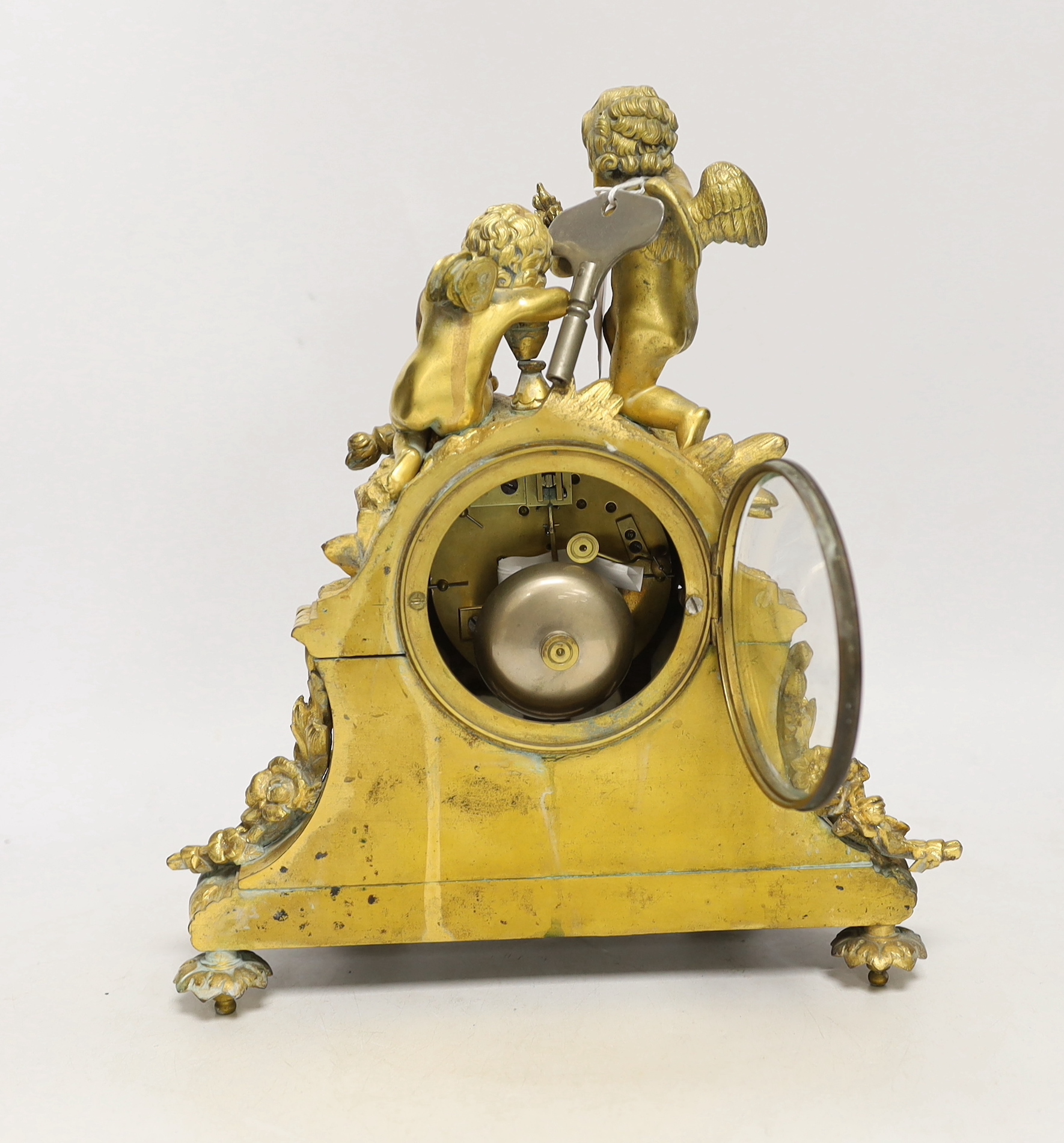 A French gilt metal enamel mantel clock surmounted with two cherubs, 30cm high